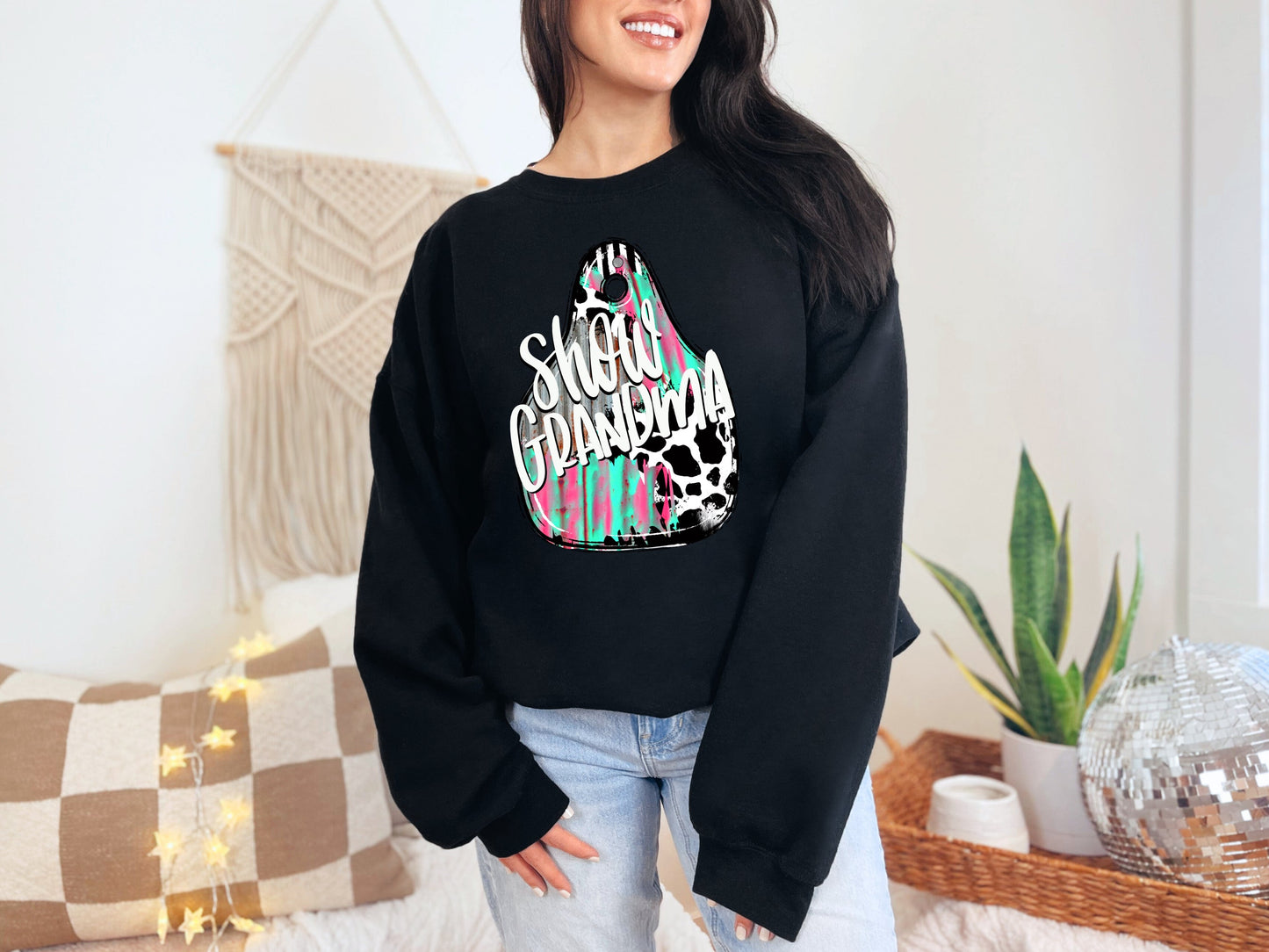 a woman wearing a black sweatshirt that says happy birthday