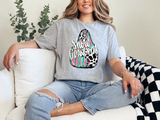 a woman sitting on a couch wearing a gray shirt